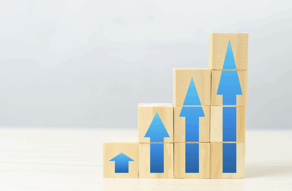Four stacks of blocks with a blue arrow on the front of each, increasing in height from left to right